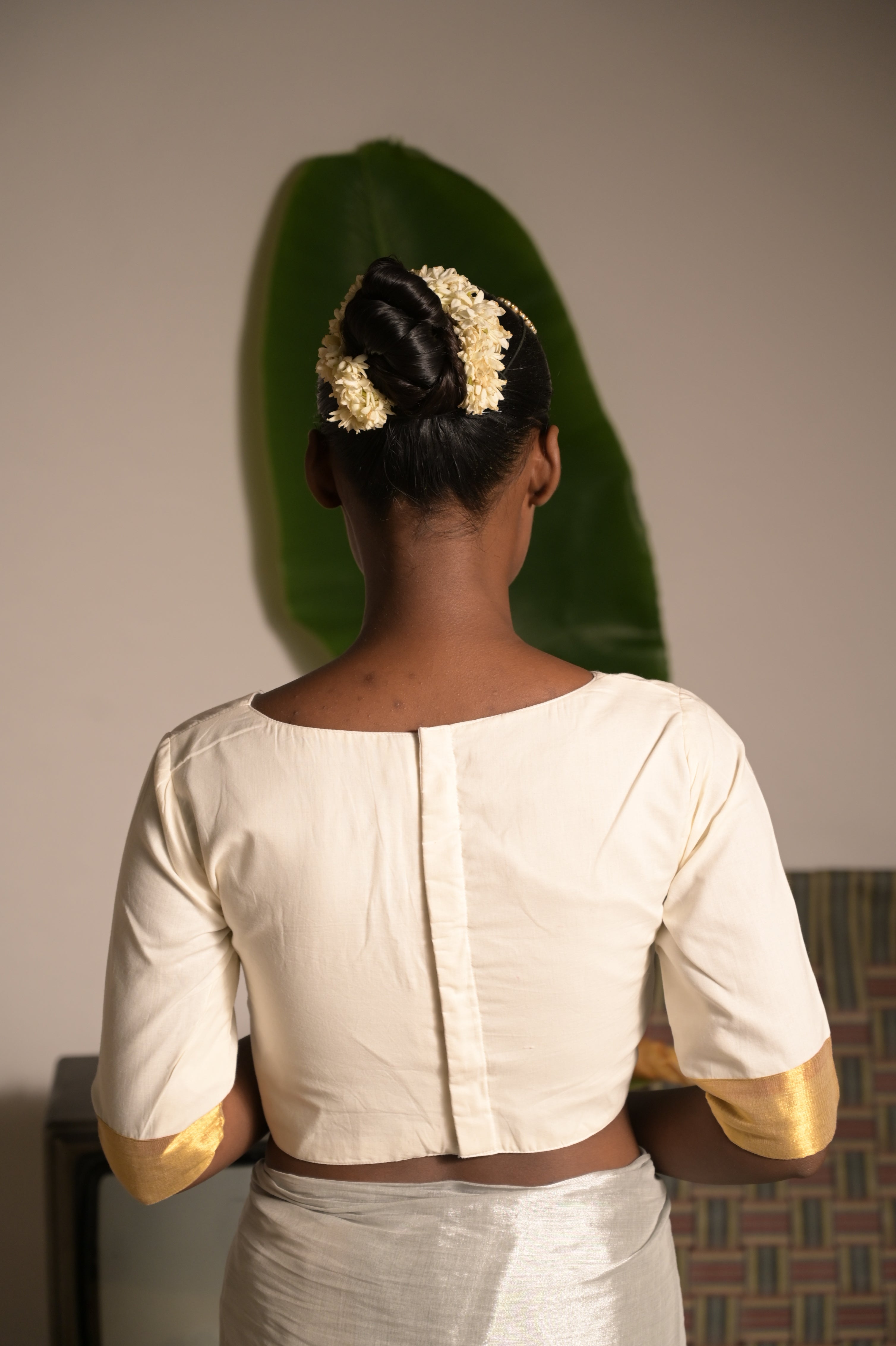 Shwetambara I White cotton blouse with golden border on sleeves