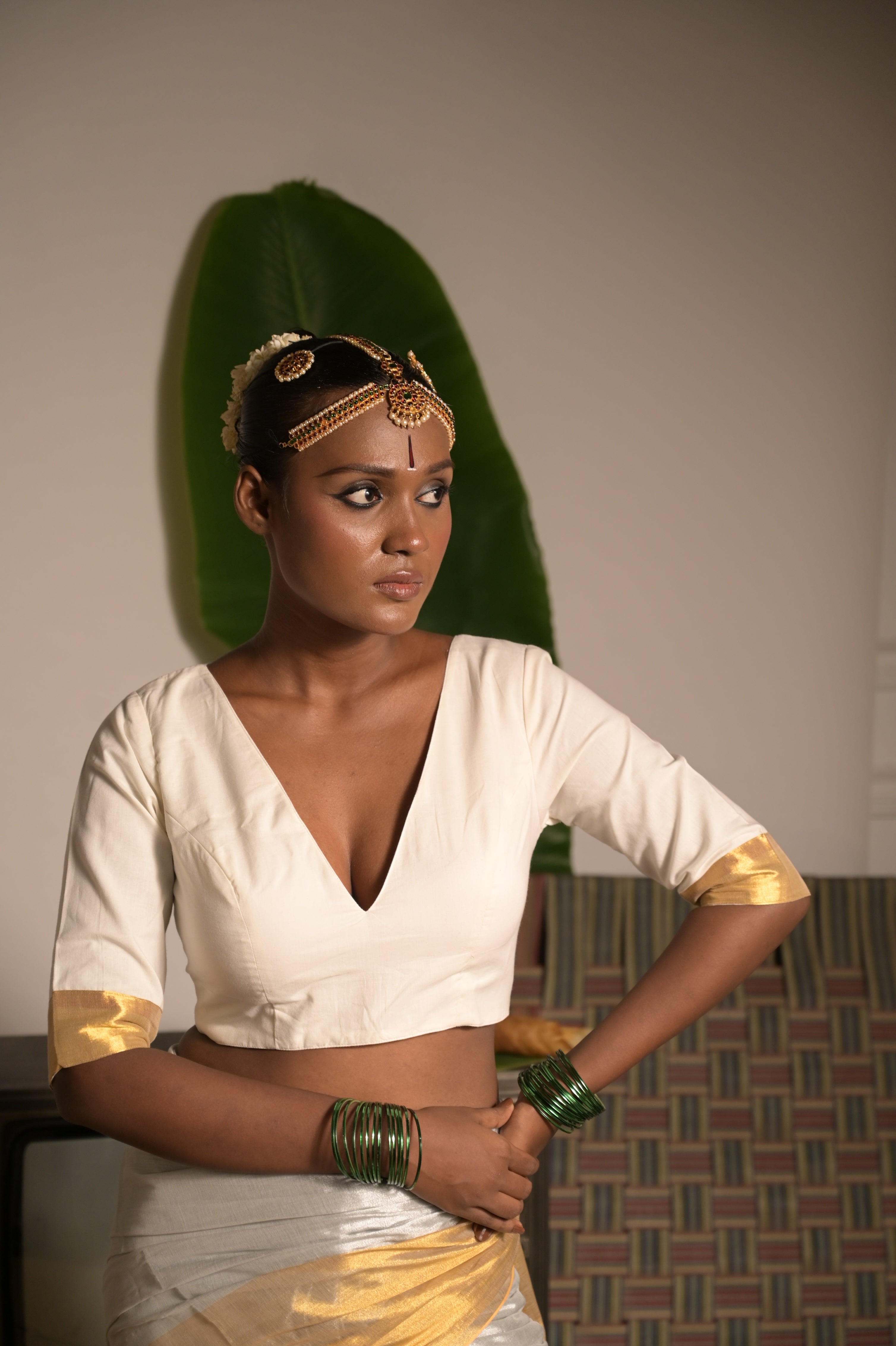 Shwetambara I White cotton blouse with golden border on sleeves