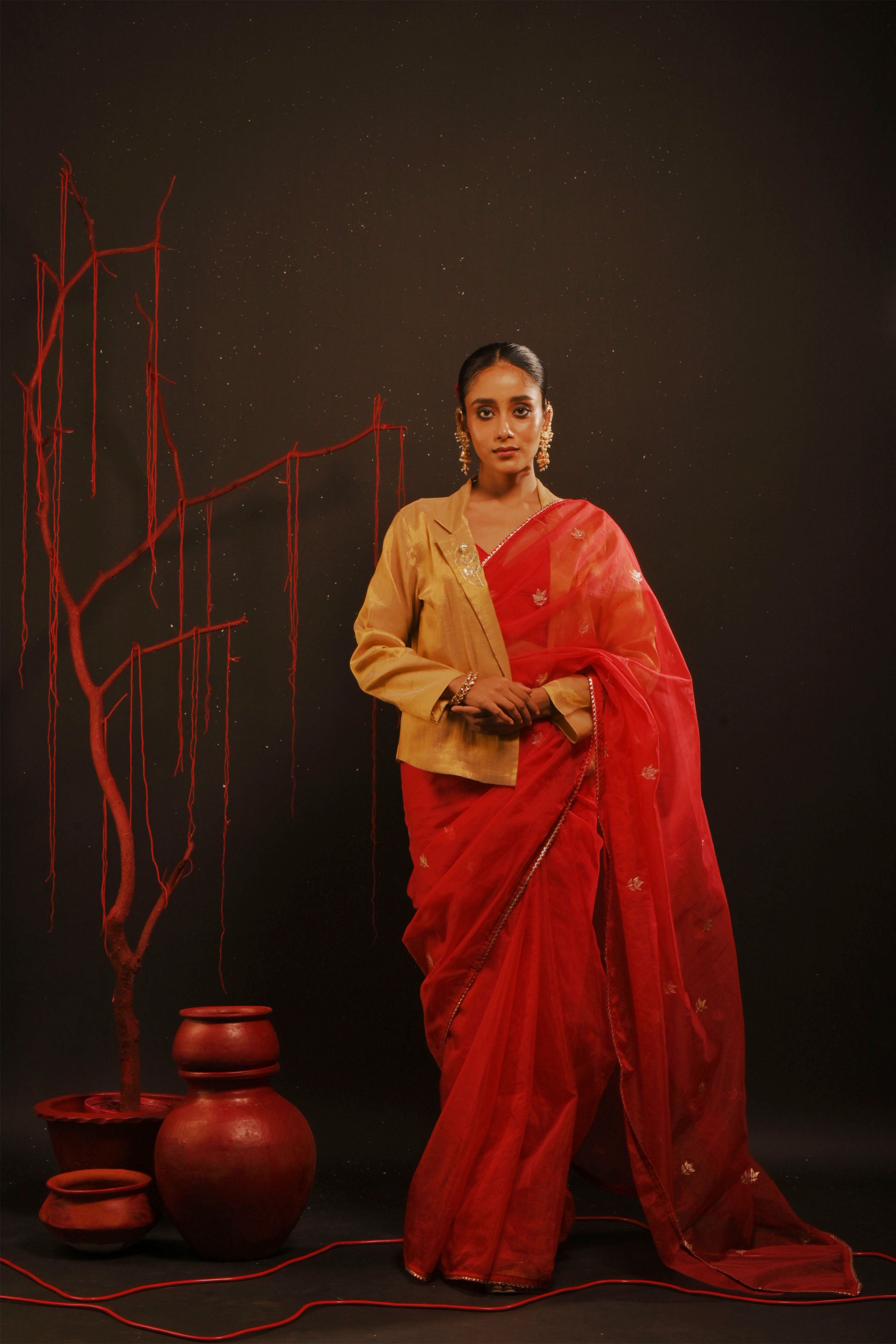 Mihira I Red organza saree paired with red chinon blouse and Tissue jacket