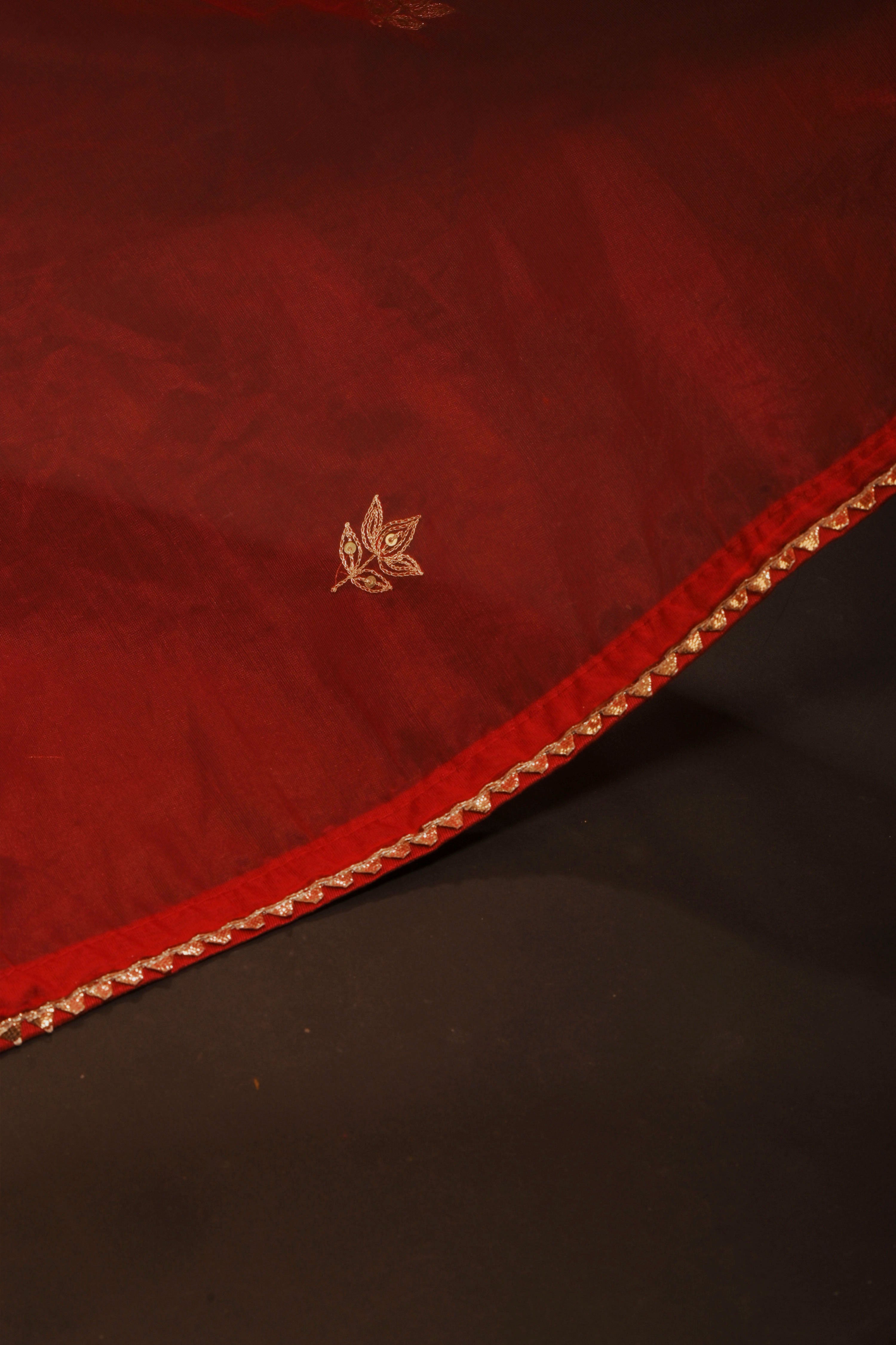 Mihira I Red organza saree paired with red chinon blouse and Tissue jacket