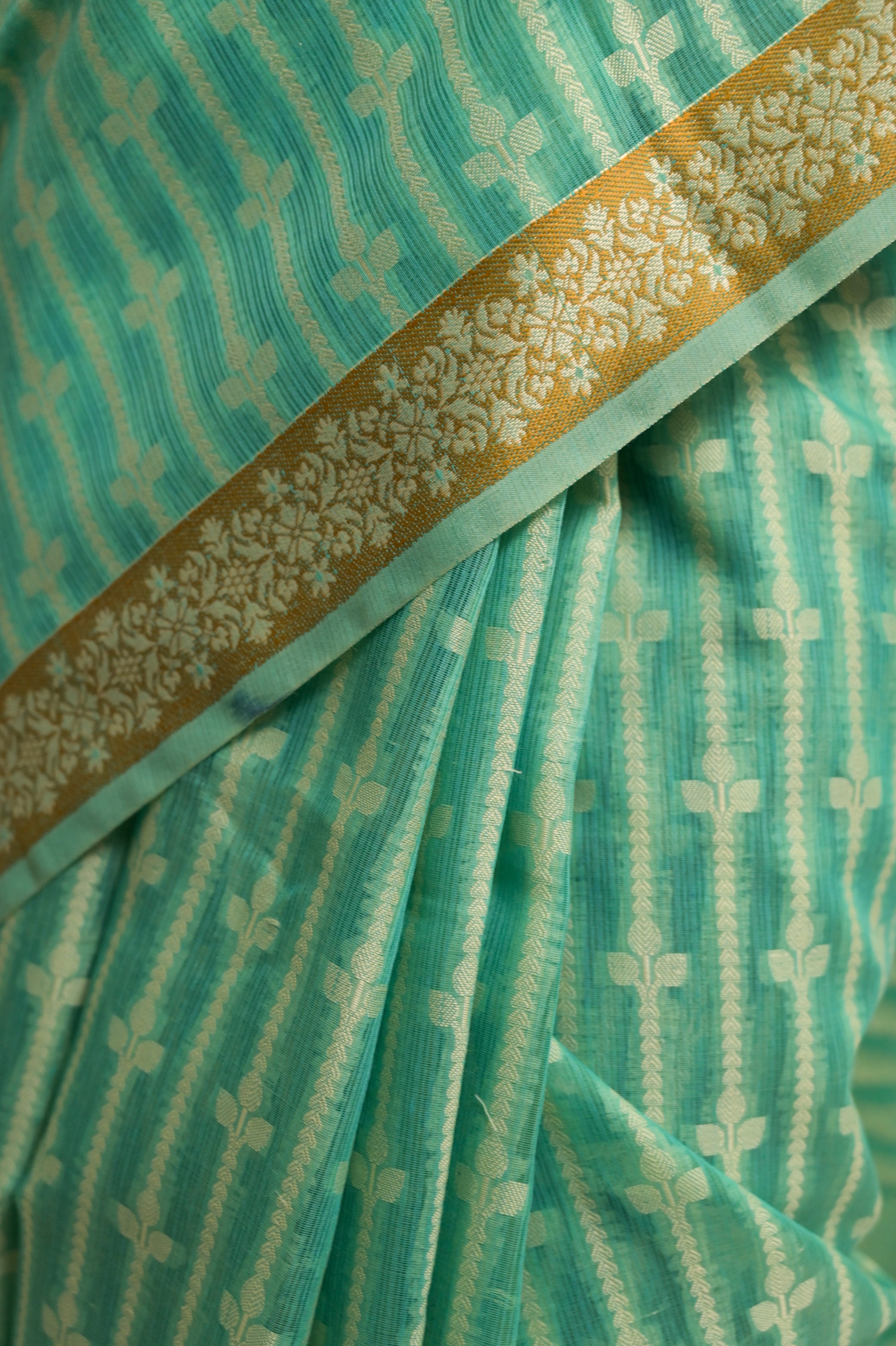 Amaaya I Sea Green Handloom Cotton Banarasi Saree with Floral Border and striped leave vines