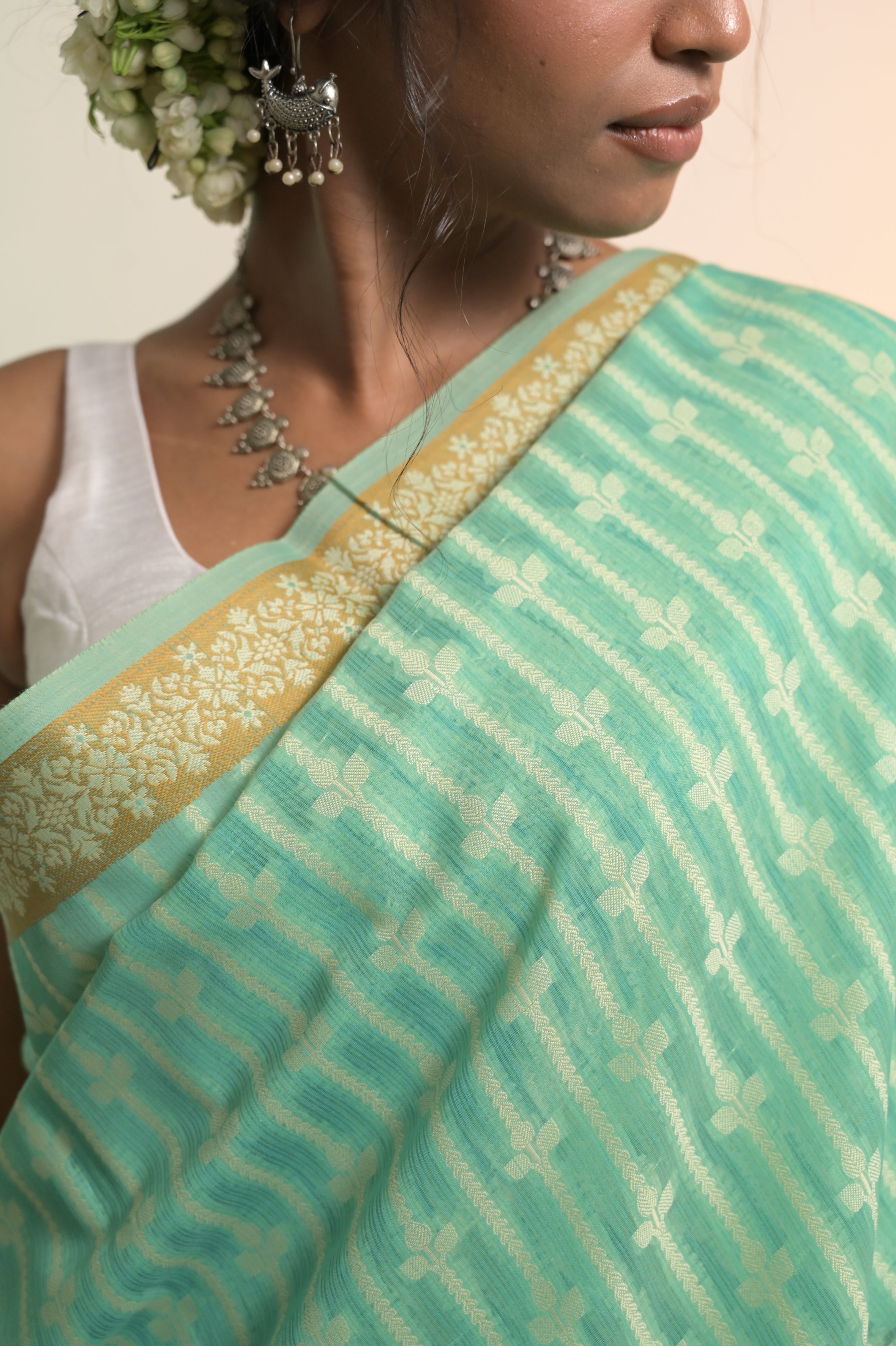 Amaaya I Sea Green Handloom Cotton Banarasi Saree with Floral Border and striped leave vines