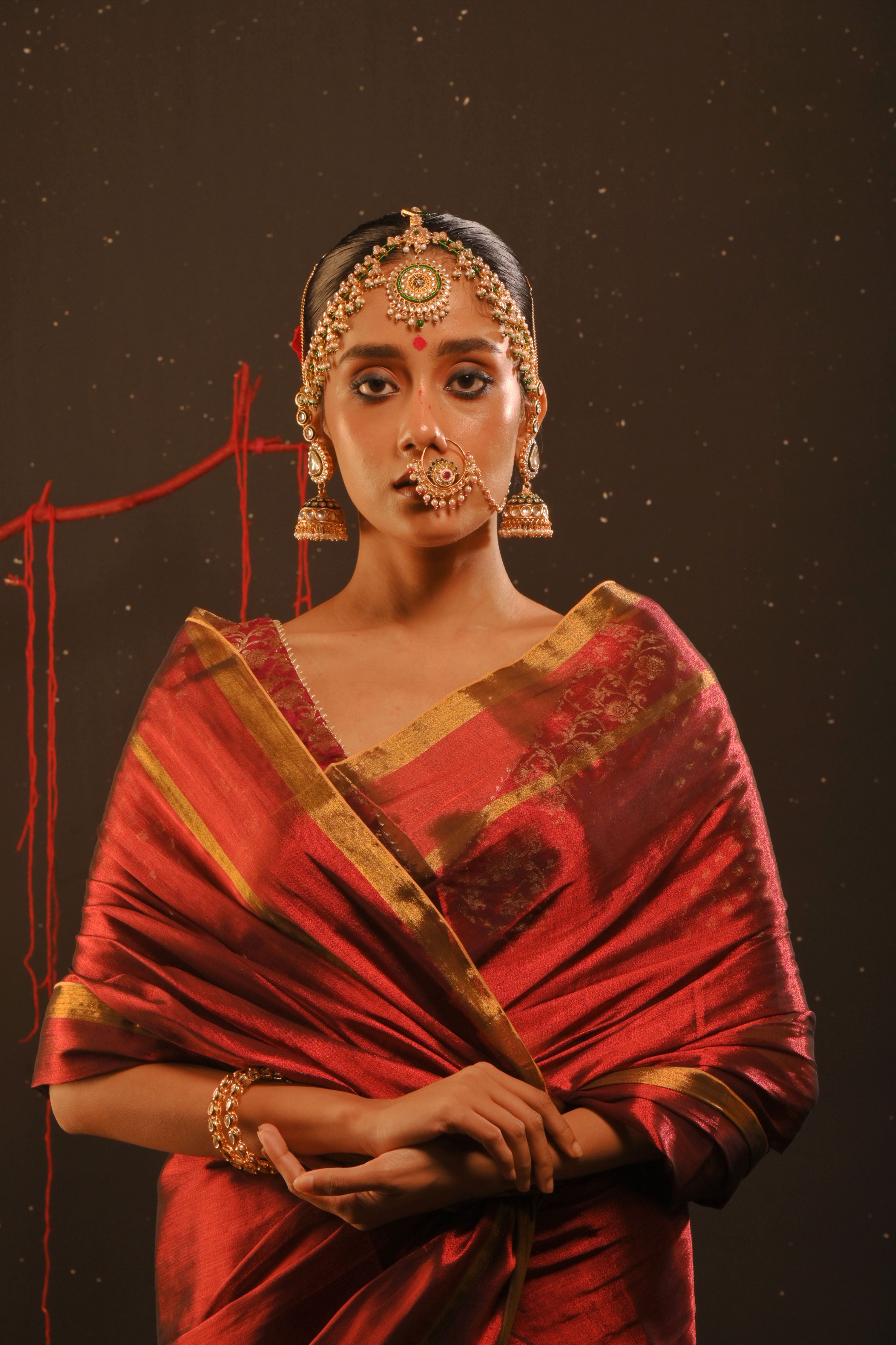 Daivika I Red handwoven tissue saree with gold striped border